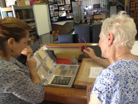 Sue shows Helen an archival album for cards and photographs.