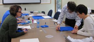 Textile workshop - Dr. Michael Marendy demonstrating how to make a textile  mounting system . (Image courtesy of Karen Barrett)